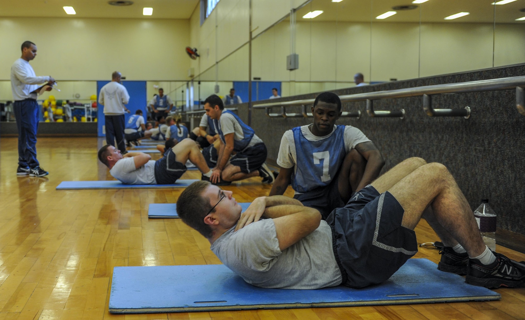 U.S. Air Force Airmen participate in a physical fitness test as physical training leaders supervise the test Dec. 1, 2016, at the Risner Fitness Center on Kadena Air Base, Japan. Physical fitness testing is a requirement for all Airmen, making sure they are fit-to-fight and carry out their unique components of the Air Force mission. (U.S. Air Force photo by Airman 1st Class Nick Emerick/Released) 