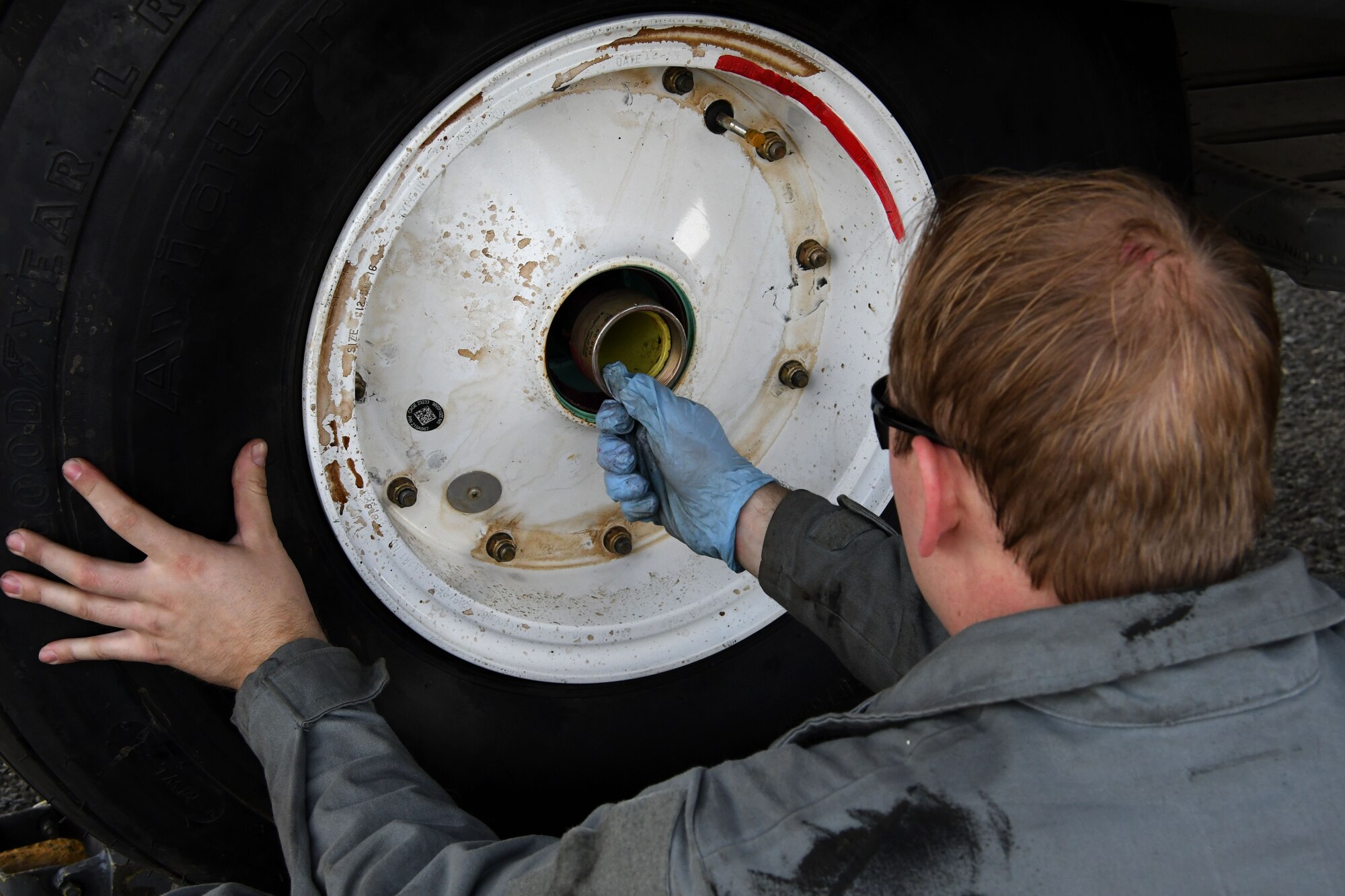 Staff Sgt. Sean Jones, a 386th Expeditionary Aircraft Maintenance Squadron aerospace maintenance craftsman, secures a wheel to the axle of an EC-130H Compass Call Dec. 5, 2016 at an undisclosed location in Southwest Asia. The EC-130s are regularly moved between the 386th and Davis-Monthan Air Force Base. (U.S. Air Force photo/Senior Airman Andrew Park)