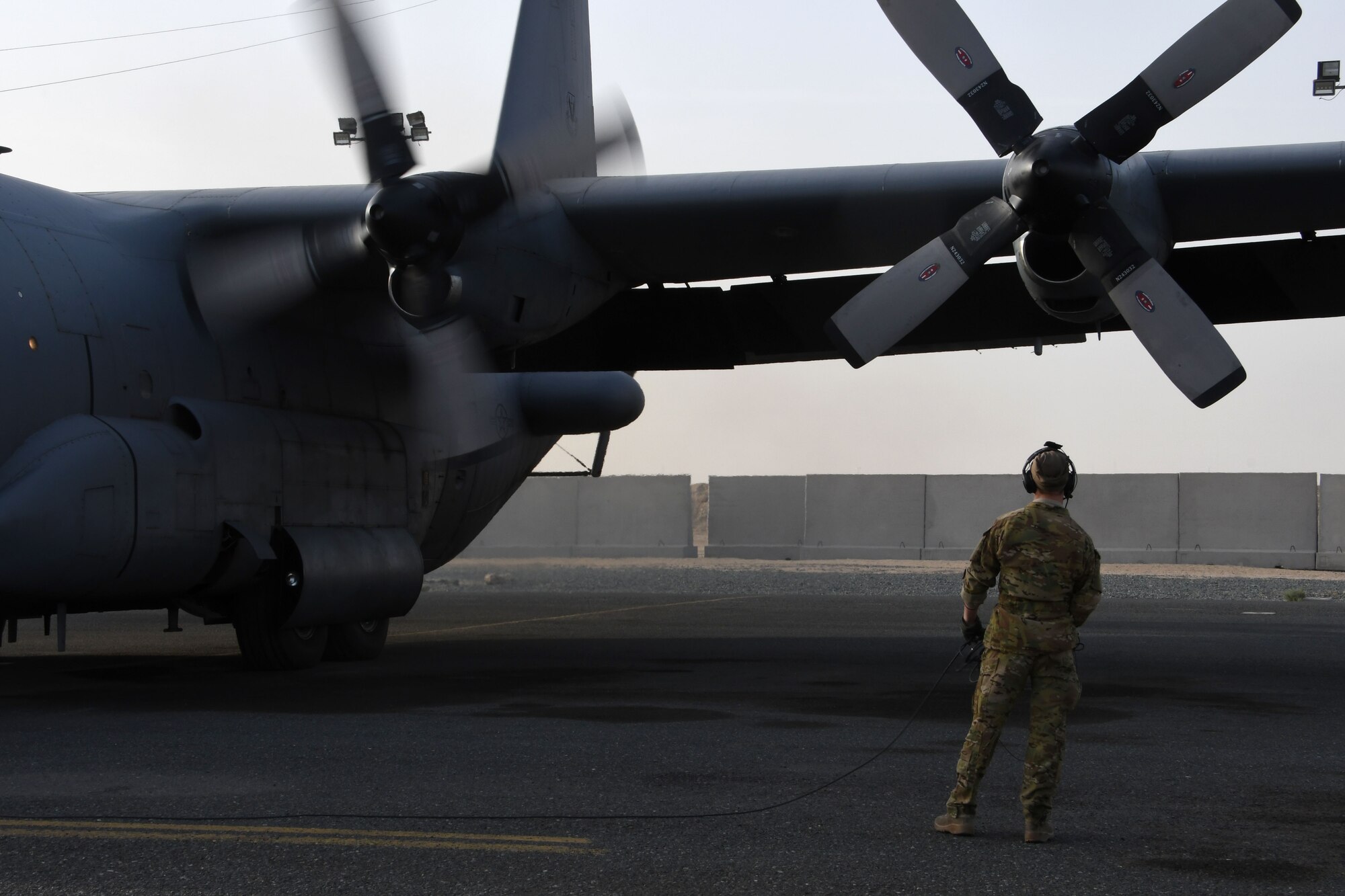 A 386th Expeditionary Operations Group airborne maintenance technician monitors an EC-130H Compass Call as it starts its engines on Dec. 5, 2016 at an undisclosed location in Southwest Asia. The Compass Call is engaged in operations jamming Da’esh communications in order to confuse and disorient enemy fighters. (U.S. Air Force photo/Senior Airman Andrew Park)
