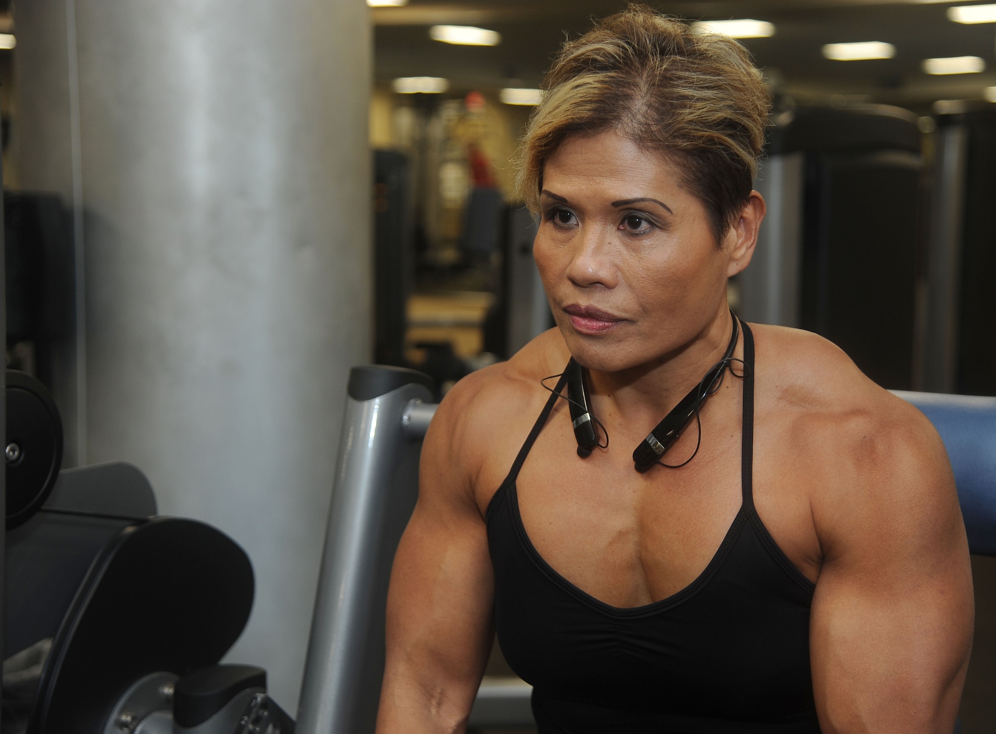 Maria Flores, a retired U.S. Army sergeant first class, uses a shoulder press machine during her workout at MacDill Air Force Base, Fla., Dec. 8, 2016. Flores, who is an award-winning bodybuilder, competed in the 2016 National Physique Committee United States Nationals for bodybuilding where she won the over 40, 45 and 50 age categories. (U.S. Air Force photo by Airman 1st Class Adam R. Shanks)