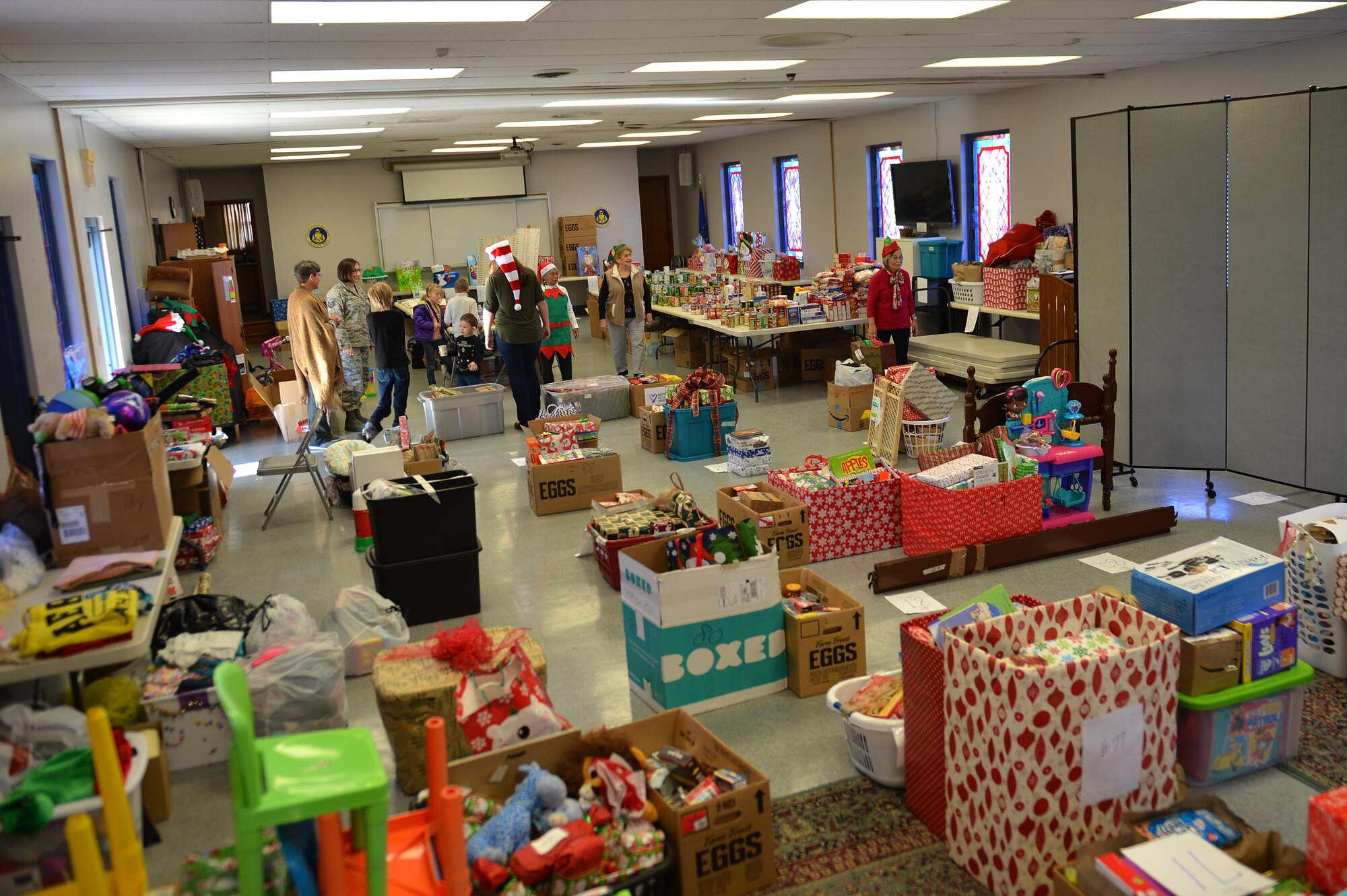 Volunteers hold a meeting before returning to work during an Operation True Giving food and gift drive at the Palmetto Chapel on Shaw Air Force Base, S.C., Dec. 9, 2016. The drive gave volunteers the opportunity to provide less fortunate families and individuals with a holiday meal and gifts to celebrate the holidays. (U.S. Air Force photo by Airman 1st Class Christopher Maldonado)