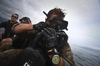 A U.S. Reconnaissance Marine with 4th Force Reconnaissance Battalion preps his scuba gear during dive operations in Kaneohe Bay, Hawaii, Dec. 9, 2016. The mission of Marine Corps Base Hawaii is to provide facilities, programs and services in direct support of units, individuals and families in order to enhance and sustain combat readiness for all operating forces and tenant organizations aboard MCB Hawaii.