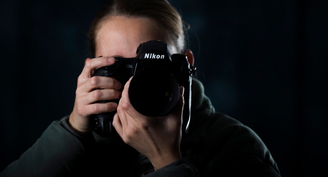 Airman 1st Class Gabrielle Spalding, 11th Wing Public Affairs photojournalist, poses for a photo in the photo studio at Joint Base Andrews, Md., Dec. 9, 2016. Spalding is one of approximately 20 Airmen and civilians that make up 11 WG PA.  (U.S. Air Force photo by Senior Airman Philip Bryant)