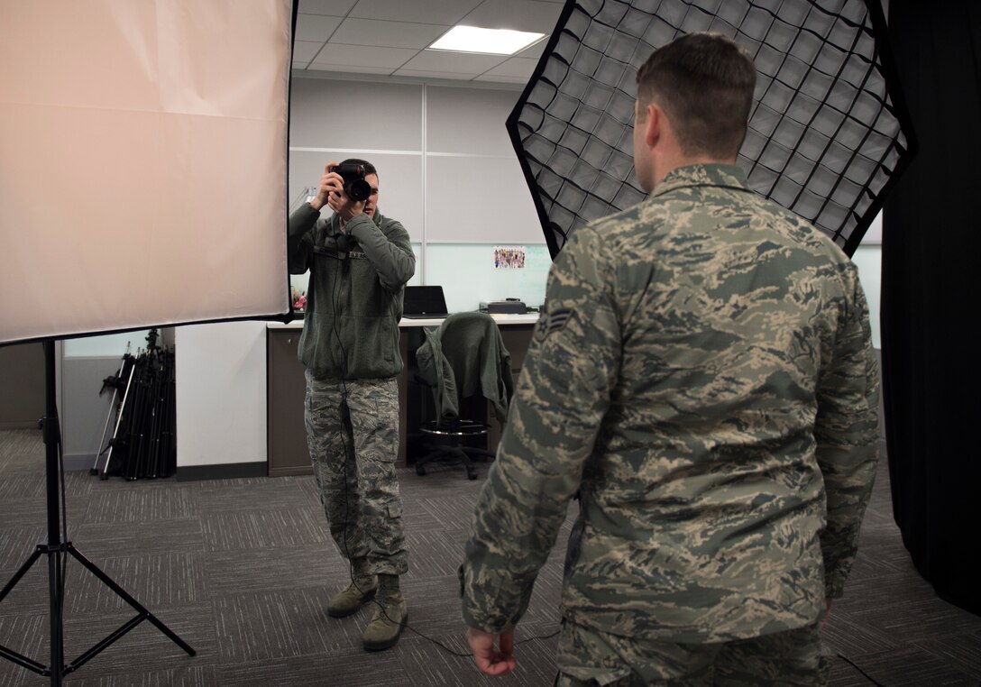 Senior Airman Ryan Sonnier, 11th Wing Public Affairs photojournalist, takes a photo of an Air Force member as part of the inauguration credentialing process inside the photo studio at Joint Base Andrews, Md., Dec. 9, 2016. Sonnier led the credentialing portion of the inauguration support. (U.S. Air Force photo by Senior Airman Philip Bryant)