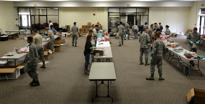 Members of Team Shaw sort cookies during the annual cookie drive at Shaw Air Force Base, S.C., Dec. 8, 2016. Members of the Greater Sumter community donated 3,852 dozen cookies to be sent to deployed service members, and delivered to Airmen and Soldiers living in the dorms on base. (U.S. Air Force photo by Airman 1st Class Kelsey Tucker)