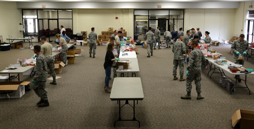 Members of Team Shaw sort cookies during the annual cookie drive at Shaw Air Force Base, S.C., Dec. 8, 2016. Members of the Greater Sumter community donated 3,852 dozen cookies to be sent to deployed service members, and delivered to Airmen and Soldiers living in the dorms on base. (U.S. Air Force photo by Airman 1st Class Kelsey Tucker)