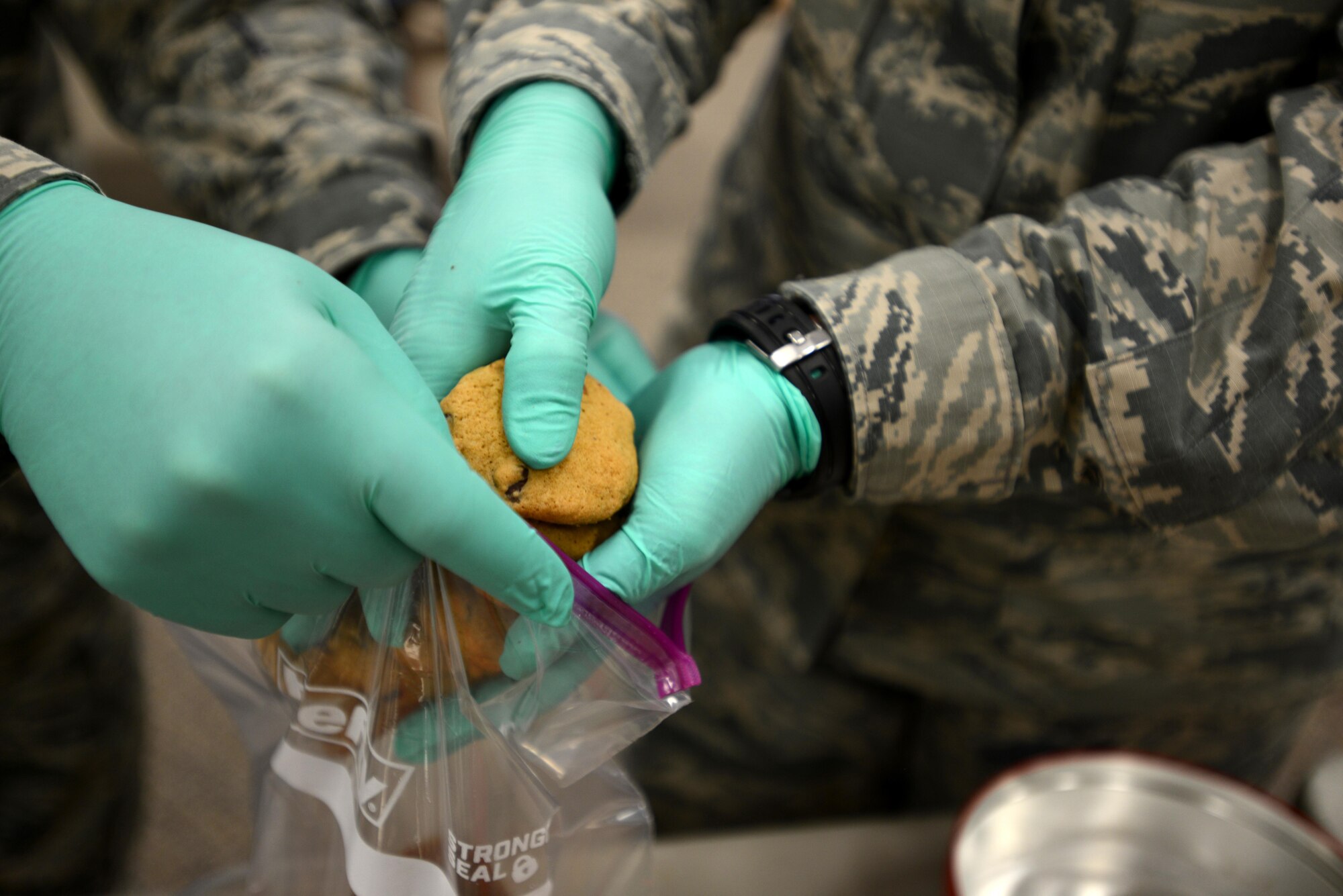U.S. Airmen sort cookies during an annual cookie drive at Shaw Air Force Base, S.C., Dec. 8, 2016. A variety of cookies were combined in bags before being handed off to first sergeants across Team Shaw for distribution to their Airmen and Soldiers. (U.S. Air Force photo by Airman 1st Class Kelsey Tucker)