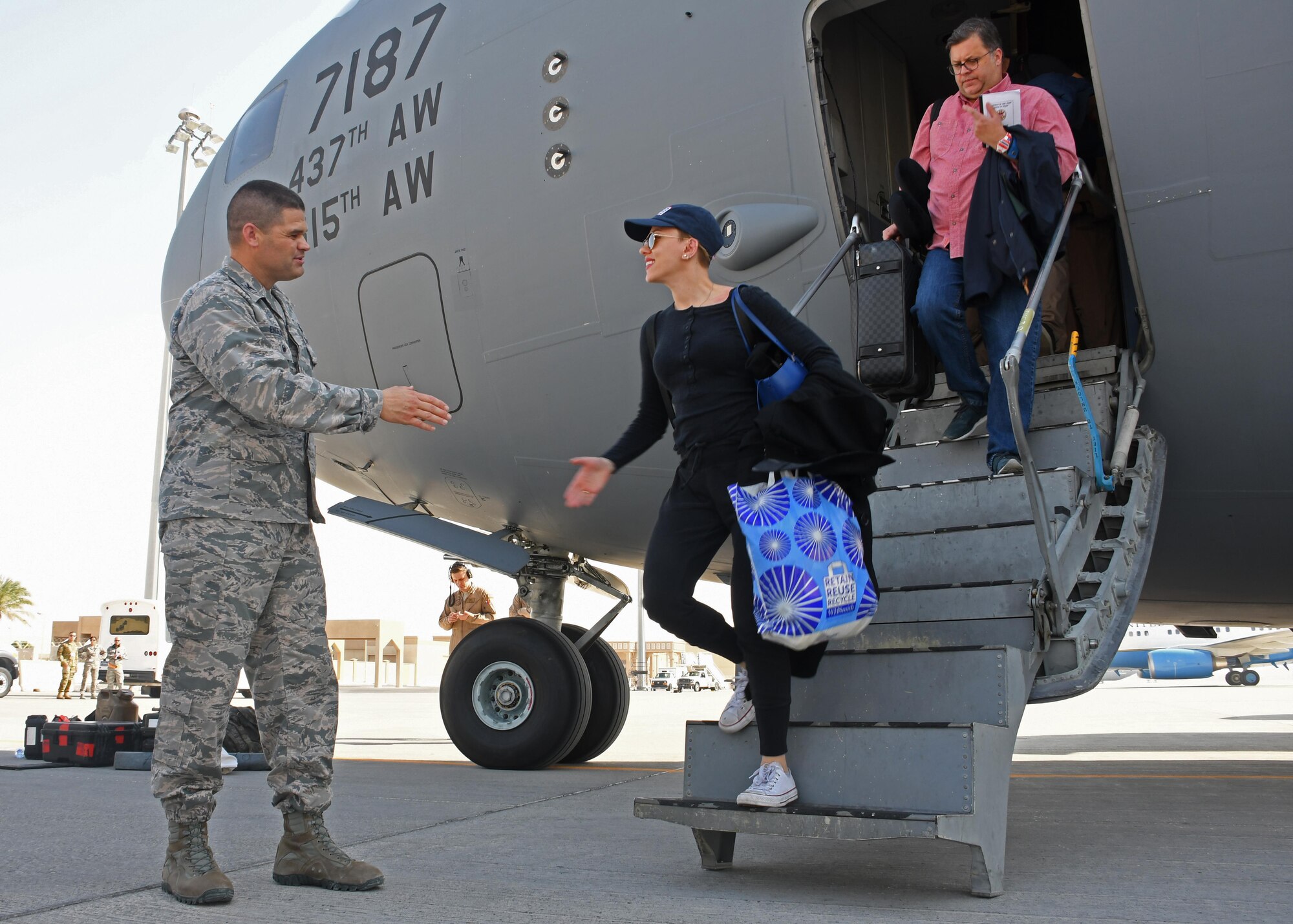 U.S. Air Force Col. Jeffrey Engelker, 379th Air Expeditionary Wing vice commander, greets actress Scarlett Johansson as she disembarks from a C-17 Globemaster at Al Udeid Air Base, Qatar, Dec. 6, 2016. Engelker greeted the celebrities, support personnel and USO staff who had come to Al Udeid as part of a holiday USO tour. (U.S. Air Force photo by Senior Airman Miles Wilson)