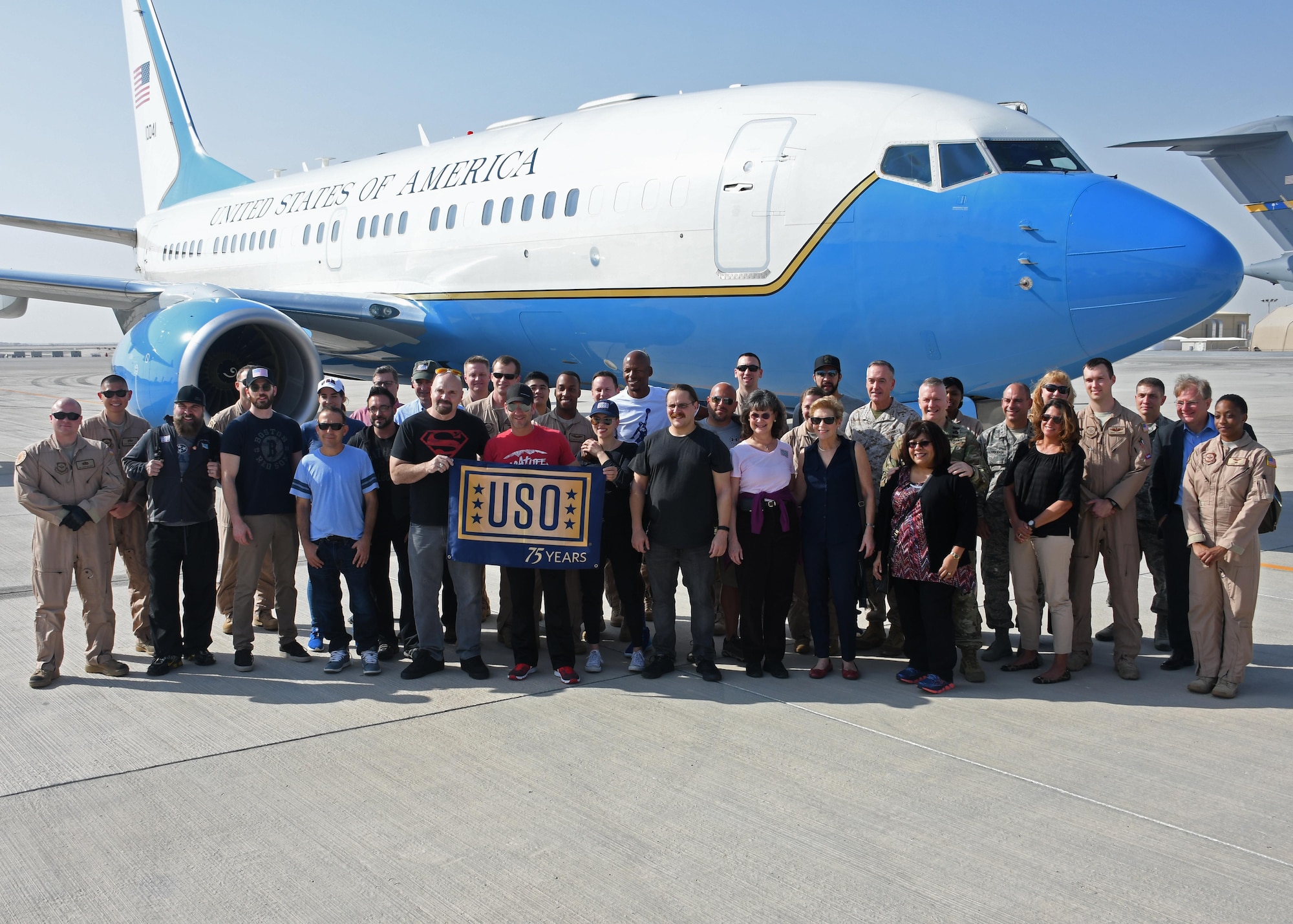 Celebrities, support personnel and USO staff stand in front of a C-40 Clipper for a group photo at Al Udeid Air Base, Qatar, Dec. 6, 2016. The group traveled on a USO tour around the theater to visit U.S. service members for the holidays. (U.S. Air Force photo by Senior Airman Miles Wilson)