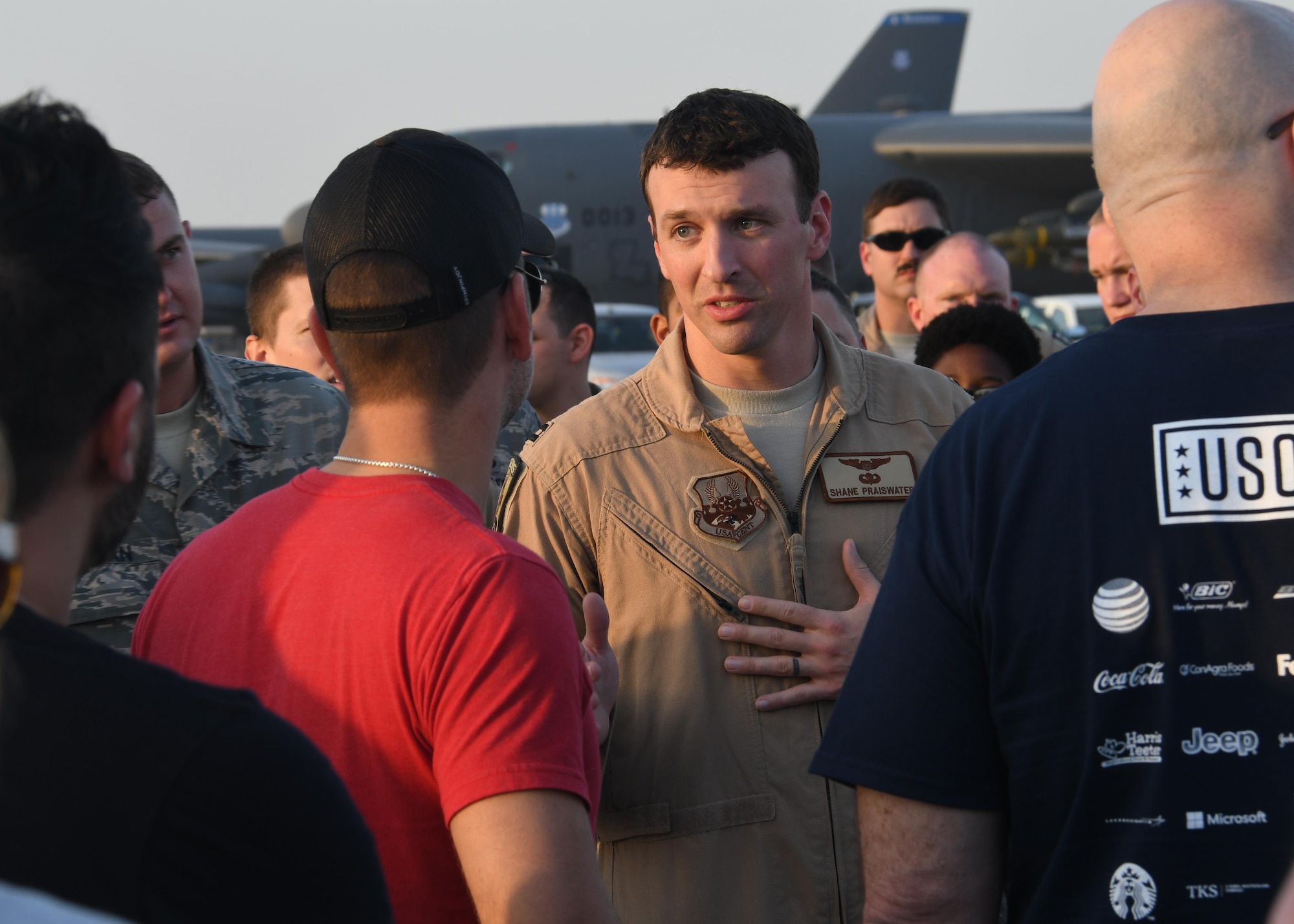 U.S Air Force Captain Shane Praiswater, 96th Expeditionary Bomber Squadron assistant director of operations, gives a briefing to celebrities, support personnel and USO Staff members at Al Udeid Air Base, Qatar, Dec. 6, 2016. Praiswater described the mission and capabilities at Al Udeid to the group, who were going on their way around the base during a holiday USO tour. (U.S. Air Force photo by Senior Airman Miles Wilson)