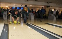 Tech. Sgt. Antonio Couto, 450th Intelligence Squadron all-source analyst, acts as a “bowling buddy” for Phillip, a Winter Special Olympics participant, at Vogelweh Military Complex, Germany, Dec. 2, 2016. Approximately 70 Airmen from the 450th IS volunteered at several locations throughout the Kaiserslautern Military Community during their second annual service day. (U.S. Air Force photo by Senior Airman Tryphena Mayhugh)