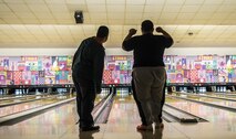 Tech. Sgt. Antonio Couto, 450th Intelligence Squadron all-source analyst, and Phillip, a Winter Special Olympics participant, watch a bowling ball roll down a lane at Vogelweh Military Complex, Germany, Dec. 2, 2016. Couto volunteered as a “bowling buddy” for the Special Olympics as a part of his squadron’s second annual service day. On the first Friday of December, the 450th IS Airmen volunteered throughout the Kaiserslautern Military Community as their way to give back to the community.  (U.S. Air Force photo by Senior Airman Tryphena Mayhugh)