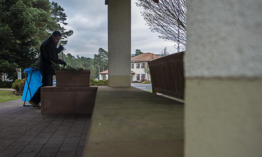 Capt. Ryan Tamez, 450th Intelligence Squadron weapons and tactics flight commander, sweeps a pavilion to prepare for the Fisher House’s tree-lighting ceremony at Landstuhl Regional Medical Center, Germany, Dec. 2, 2016. Several Airmen assigned to 450th IS helped distribute cookies, set up and tear down the event as a part of the squadron’s second annual service day. On the first Friday of December, the 450th IS Airmen volunteered throughout the Kaiserslautern Military Community as their way to give back to the community. (U.S. Air Force photo by Senior Airman Tryphena Mayhugh)