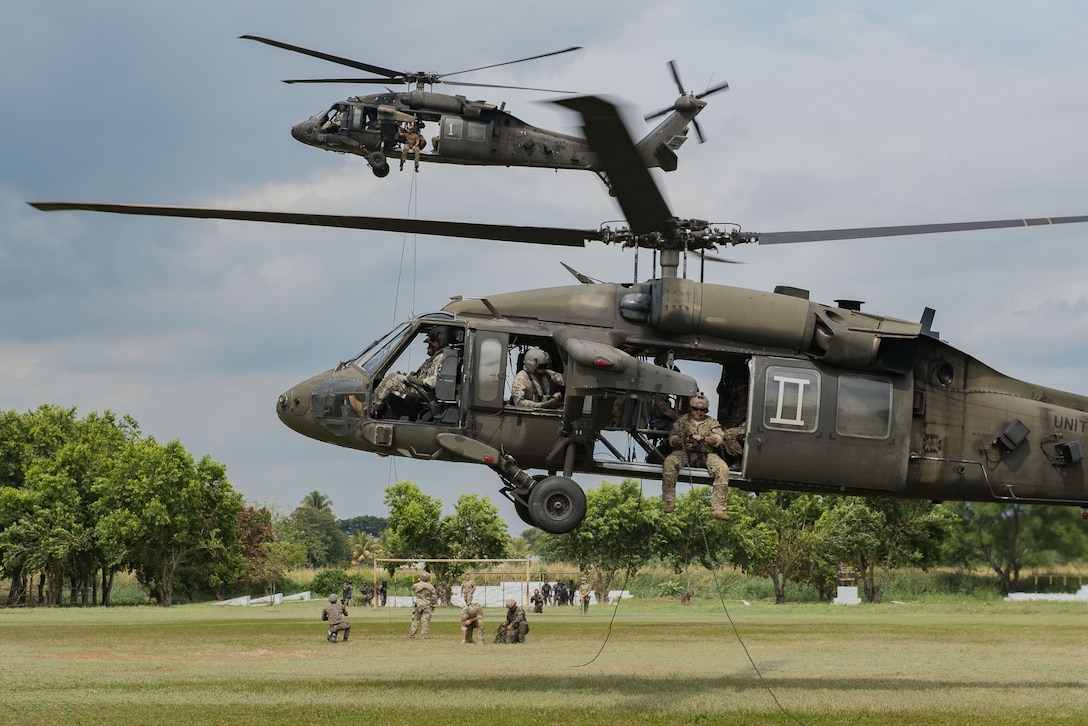 A pair of UH-60 Blackhawk helicopters assigned to Joint Task Force-Bravo’s 1st Battalion 228th Aviation Regiment provide aviation support during Operation Serpiente, a joint air assault training mission led by members of the U.S. 7th Special Forces Group and Naval Special Warfare, Nov. 28 – Dec. 2, at Ilopango Airport, El Salvador.