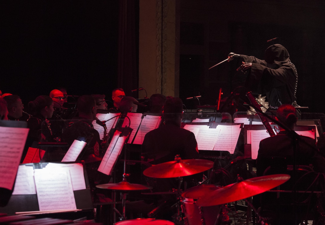 Gunnery Sgt. Justin A. Hauser, enlisted conductor of Marine Corps Band New Orleans, conducts the band as the Ghost of Christmas Past during the “Santa Meets Sousa” holiday concert at Saenger Theatre, Dec. 10, 2016. The performance was the third in the regional concert series that served to benefit the U.S. Marine Corps Reserve Toys for Tots Program. Toys for Tots is a nationwide program that collects new, unwrapped toys for less-fortunate children in the community. Since its inception in 1947, Toys for Tots has distributed 512 million toys to 237 million children.