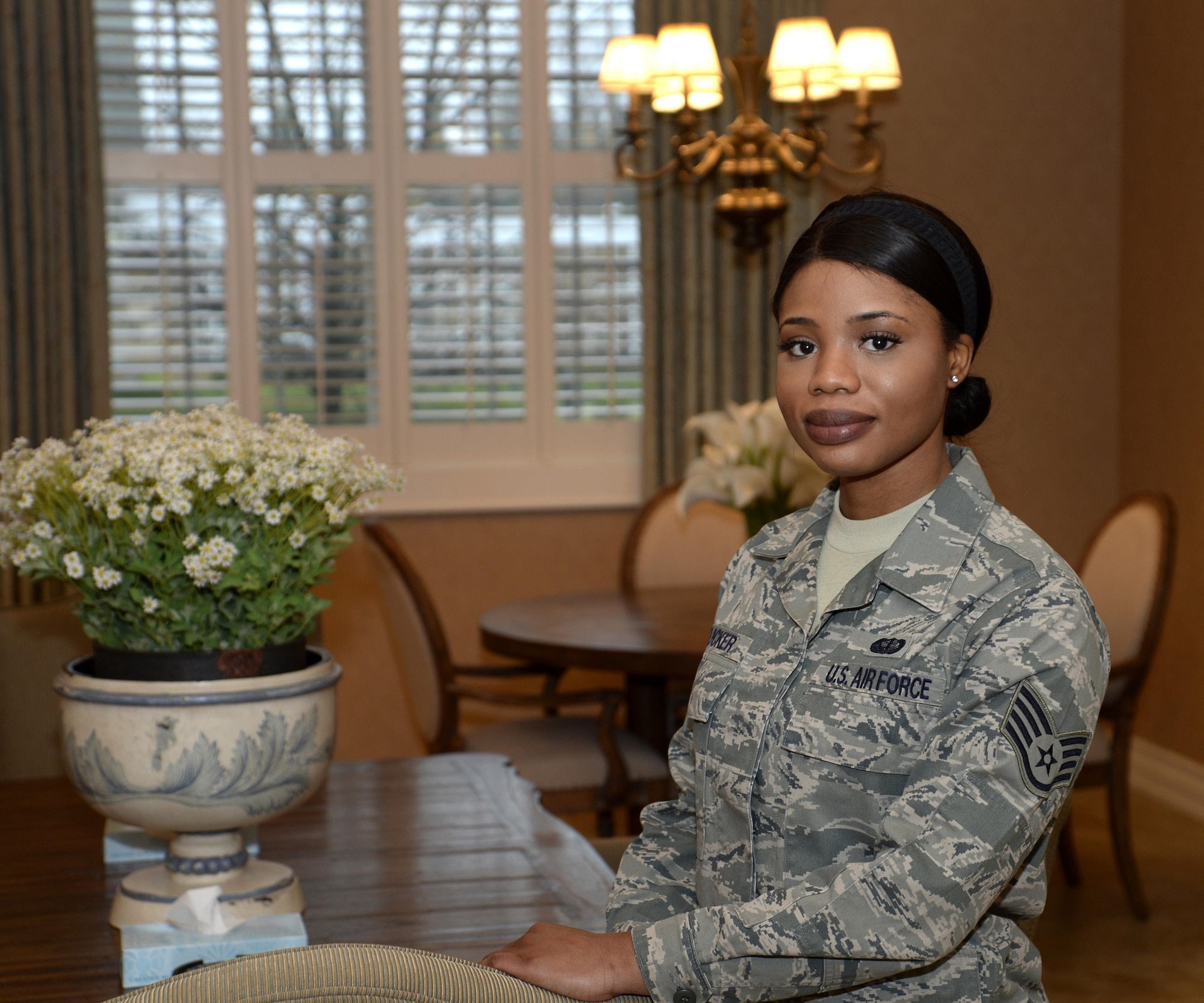 Staff Sgt. Isata Tucker, a manager on duty at the Fisher House for Families of the Fallen, Dover Air Force Base, Del., manages the facility on Dec. 12, 2016, ensuring that the property is always ready for use. Staff Sgt. Tucker survived a war in her former country of Sierra Leone, Africa. She recieved her U.S. citizenship on the same day she graduated from Air Force Basic Military Training in 2013.