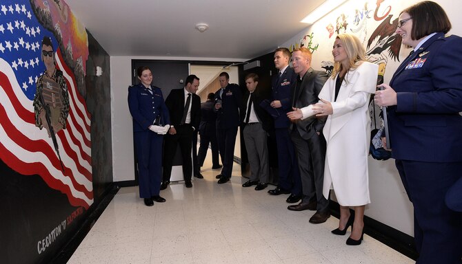 Brittany Bird (left, in white), looks upon a mural honoring her husband, retired Capt. Carson Bird, in a hallway of Cadet Squadron 09, Dec. 9, 2016, at the U.S. Air Force Academy. Carson Bird, a 2008 graduate of the Academy, was assigned to CS-09 as a cadet. He died Nov. 26, 2016, after battling Chondrosarcoma, a rare form of bone cancer. A memorial in his honor took place at the Cadet Chapel Dec. 9, 2016. (U.S. Air Force photo/Mike Kaplan)