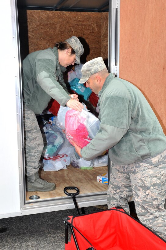 U.S. Air Force Tech. Sgt. Christina Rucoba, 316th Training Squadron instructor, hands toys to Master Sgt. Christopher Francis, 17th Contracting Squadron superintendent, during delivery to the Court Appointed Special Advocates for Children center in San Angelo, Texas, Dec. 8, 2016. Goodfellow dropped off gifts for 340 children in emergency foster care. (U.S. Air Force photo by Staff Sgt. Laura R. McFarlane/Released)