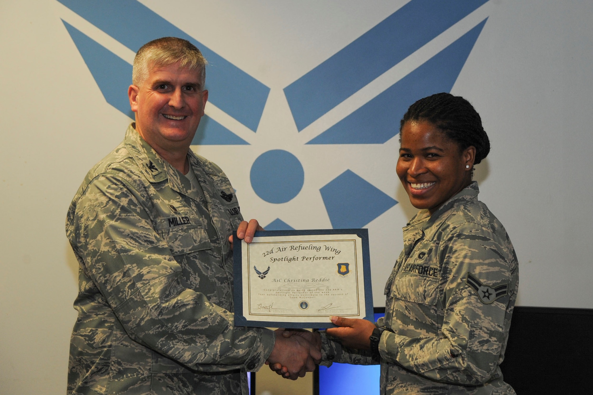Airman 1st Class Christina Reddie, 22nd Logistics Readiness Squadron vehicle operator, poses with Col. Albert Miller, 22nd Air Refueling Wing commander, Dec. 12, 2016, at McConnell Air Force Base, Kan. Reddie received the spotlight performer for the week of Nov. 28- Dec. 2. (U.S. Air Force photo/Airman 1st Class Jenna K. Caldwell)