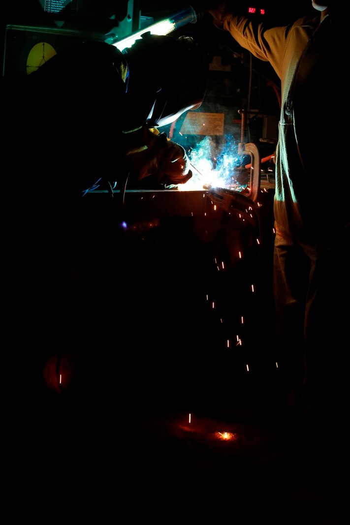 U.S. Marine Cpl. Franky Mitchell, a welder with Heavy Equipment Platoon, 1st Maintenance Battalion, 1st Marine Logistics Group, welds pieces of metal together during exercise Steel Knight at Marine Corps Air Ground Combat Center Twentynine Palms, Calif., Dec. 8, 2016. Steel Knight 2017 is a 1st Marine Division-led exercise that exposes Marines and Sailors to skill sets necessary to operate as a fully capable Marine air ground task force. Mitchell is from Ocata, Fla. (U.S. Marine Corps photo by PFC Timothy Shoemaker)
