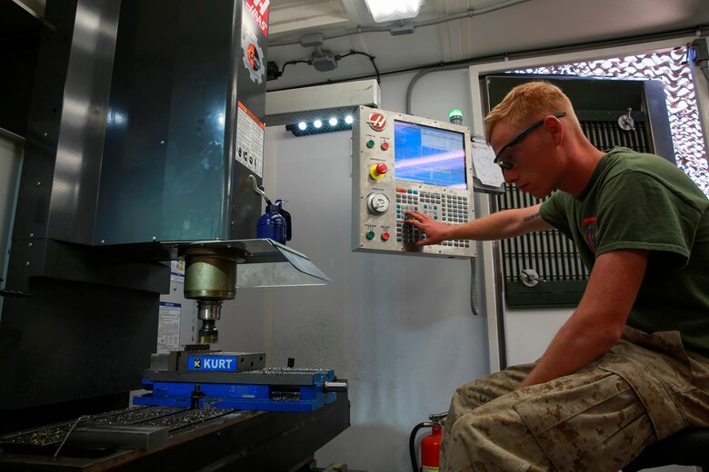 .S. Marine Cpl. Rusty Mongold, a machinist with Engineer Maintenance Company, 1st Maintenance Battalion, 1st Marine Logistics Group cuts a piece of metal using the Computer Numerical Control during exercise Steel Knight at Marine Corps Air Ground Combat Center Twentynine Palms, Calif., Dec. 8, 2016. Steel Knight 2017 is a 1st Marine Division-led exercise that exposes Marines and Sailors to skill sets necessary to operate as a fully capable Marine air ground task force. Mongold is from Port Arthur, Texas. (U.S. Marine Corps photo by PFC Timothy Shoemaker)