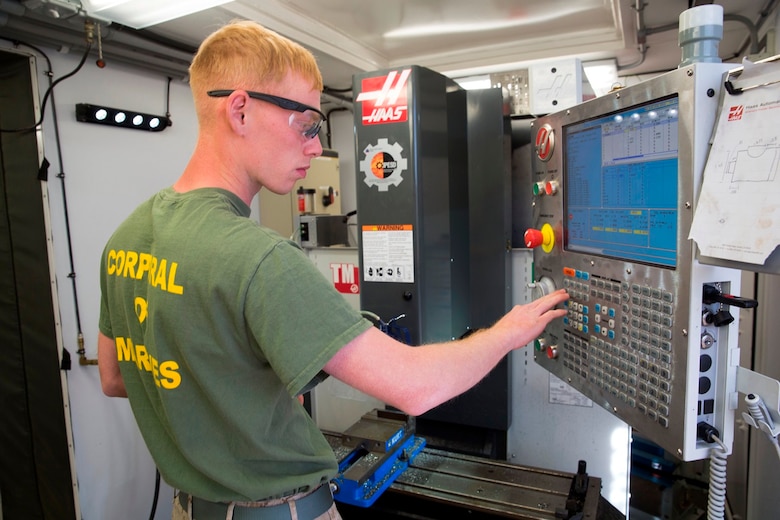 U.S. Marine Cpl. Rusty Mongold, a machinist with Engineer Maintenance Company, 1st Maintenance Battalion, 1st Marine Logistics Group, cuts a piece of metal using the Computer Numerical Control during exercise Steel Knight at Marine Corps Air Ground Combat Center Twentynine Palms, Calif., Dec. 8, 2016. Steel Knight 2017 is a 1st Marine Division-led exercise that exposes Marines and Sailors to skill sets necessary to operate as a fully capable Marine air ground task force. Mongold is from Port Arthur, Texas. (U.S. Marine Corps photo by Sgt. Abbey Perria)