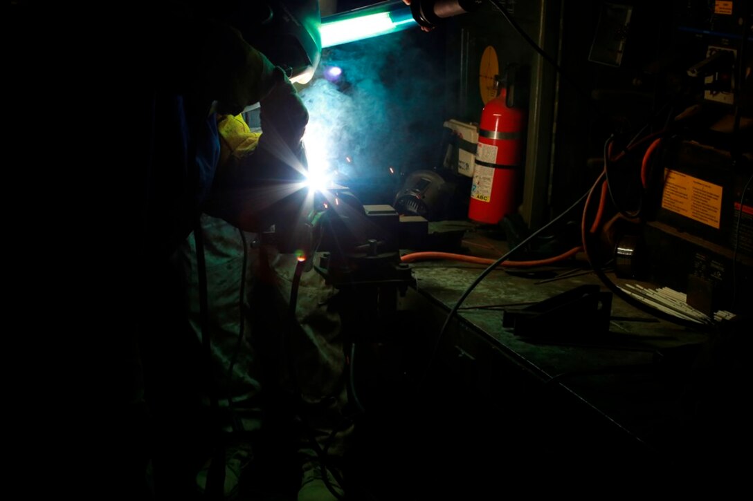 U.S. Marine Cpl. Franky Mitchell, a welder with Heavy Equipment Platoon, 1st Maintenance Battalion, 1st Marine Logistics Group, welds pieces of metal together during exercise Steel Knight at Marine Corps Air Ground Combat Center Twentynine Palms, Calif., Dec. 8, 2016. Steel Knight 2017 is a 1st Marine Division-led exercise that exposes Marines and Sailors to skill sets necessary to operate as a fully capable Marine air ground task force. Mitchell is from Ocata, Fla. (U.S. Marine Corps photo by PFC Timothy Shoemaker)
