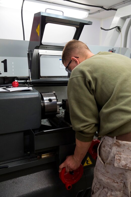 U.S. Marine Sgt. Bican Lucas, a machinist with Reparable Maintenance Company, 1st Maintenance Battalion, 1st Marine Logistics Group, makes a suspension roller for an Amphibious Assault Vehicle during exercise Steel Knight at Marine Corps Air Ground Combat Center Twentynine Palms, Calif., Dec. 8, 2016. Steel Knight 2017 is a 1st Marine Division-led exercise that exposes Marines and Sailors to skill sets necessary to operate as a fully capable Marine air ground task force. Bican is from Cleveland, Ohio. (U.S. Marine Corps photo by Sgt. Abbey Perria)