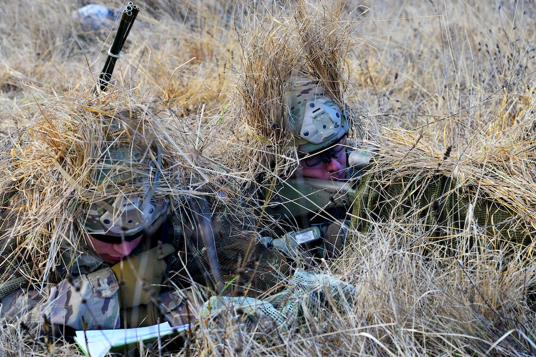 A soldier writes down distance and wind notes while Army Spc. Nicholas Logsdon, right, engages targets as part of a live-fire exercise during Exercise Mountain Shock at Pocek Range in Slovenia, Dec. 8, 2016. Logsdon is a sniper assigned to the 1st Squadron, 91st Cavalry Regiment. Army photo by Paolo Bovo