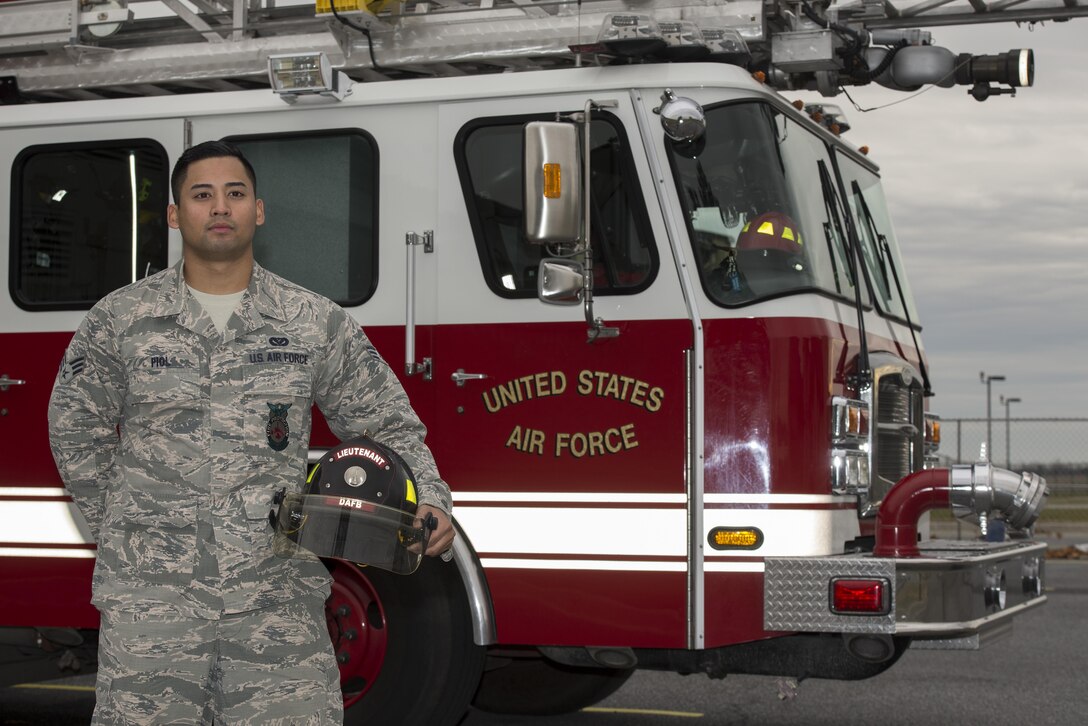 Senior Airman Jason Piol, 436th Civil Engineer Squadron fire protection journeyman stands in front of a fire truck Dec. 8, 2016, by the fire department on Dover Air Force Base, Del. The fire department remains staffed 24/7, 365 days a year to ensure fire prevention for the installation at all times. (U.S. Air Force photo by Senior Airman Aaron J. Jenne)