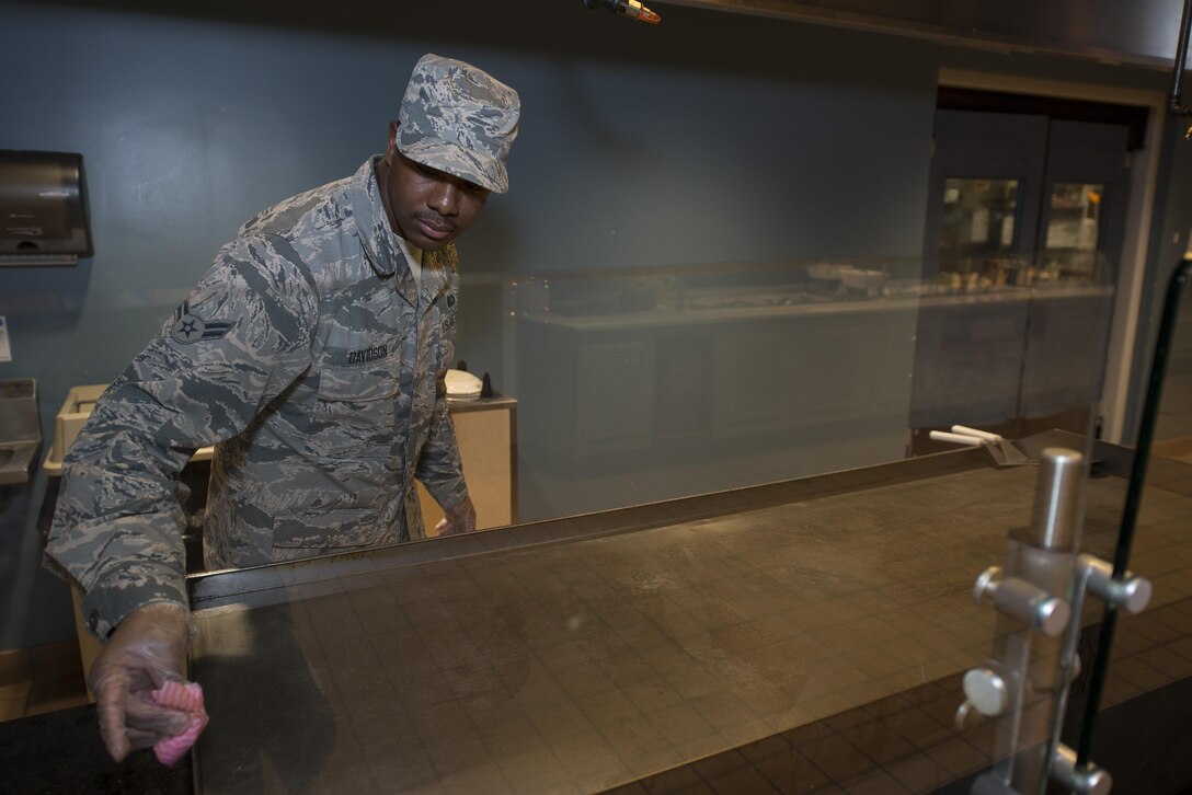 Airman 1st Class Kahlil Davidson, 436th Force Support Squadron food services technician, cleans a grill after lunch Dec. 8, 2016, at the dining facility on Dover Air Force Base, Del. The dining facility provides low cost, quality food to Airmen year-round including holidays and down days. (U.S. Air Force photo by Senior Airman Aaron J. Jenne)
