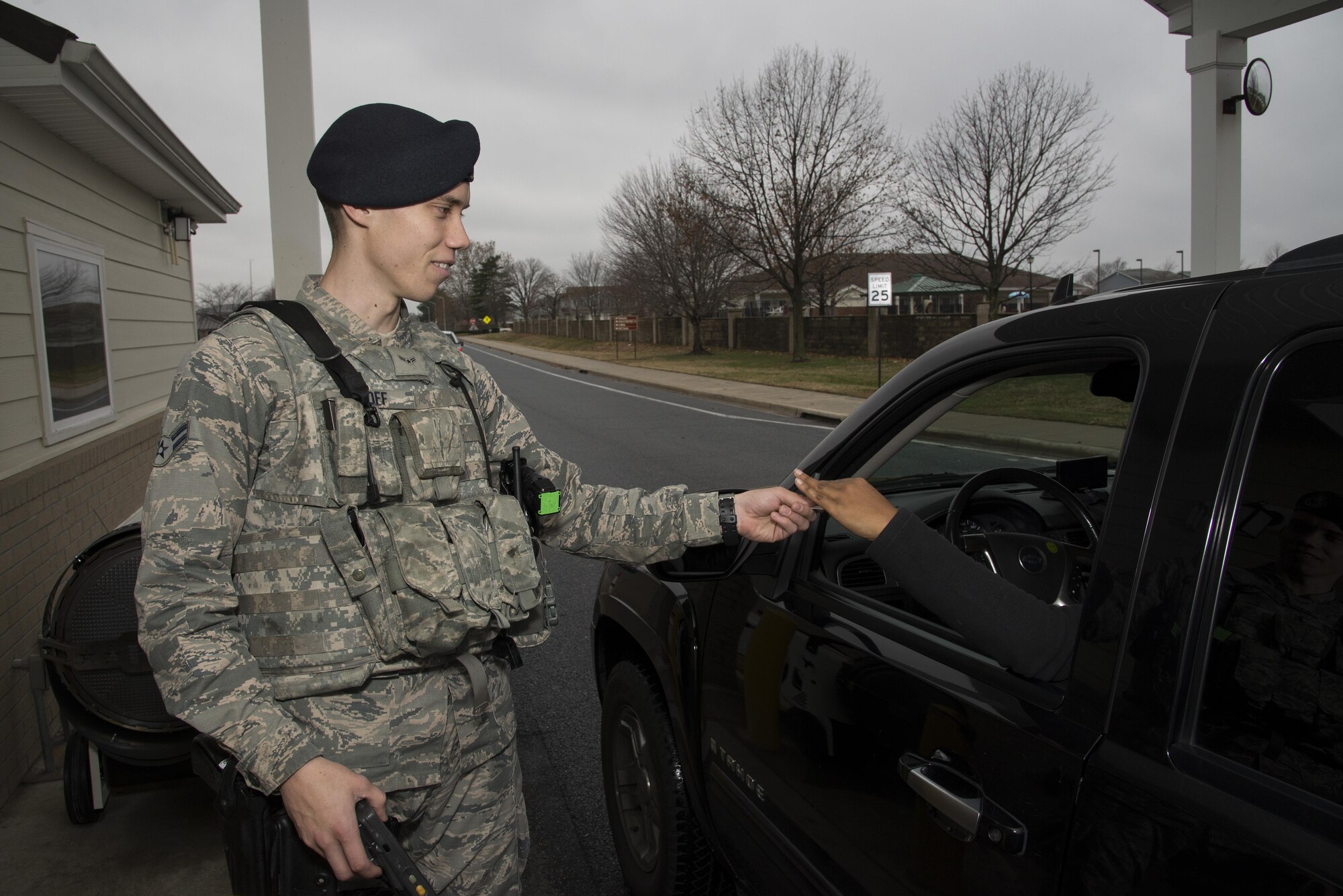 Airman 1st Class Jake Goff, 436th Security Forces Squadron defender, checks an ID card Dec. 12, 2016, at the base housing gate on Dover Air Force Base, Del. Defenders ensure year-round security coverage of the installation and its assets. (U.S. Air Force photo by Senior Airman Aaron J. Jenne)