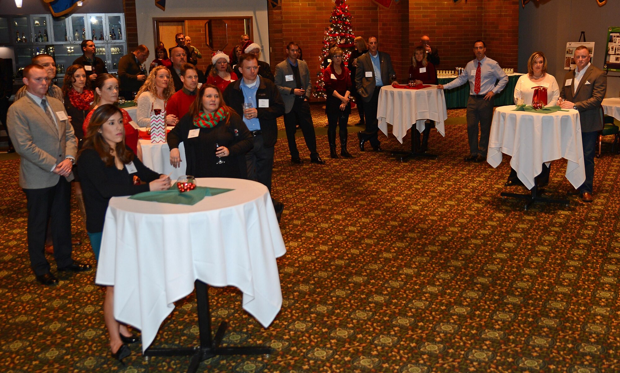 Team McChord civic leaders watch the 62nd Airlift Wing mission video during the Team McChord annual civic leader holiday party Dec. 10, 2016, at Joint Base Lewis-McChord, Wash. The holiday party was an informal event to honor Team McChord civic leaders. (U.S. Air Force photo/Senior Airman Jacob Jimenez) 