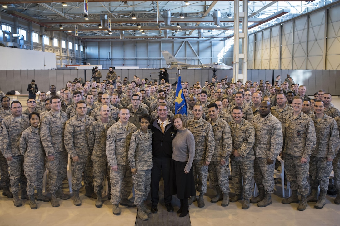 Defense Secretary Ash Carter poses for a picture with airmen assigned to the 31st Mission Support Group at Aviano Air Base, Italy.