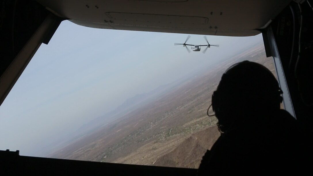 A crew chief with Marine Medium Tiltrotor Squadron (VMM) 364 observes an MV-22B Osprey during exercise Sea Horse Wind, Dec. 6. Sea Horse Wind was a long-range raid conducted by over 600 Marines with the 3rd Marine Aircraft Wing and the 1st Marine Division. (U.S. Marine Corps photo by Sgt. Lillian Stephens/Released)