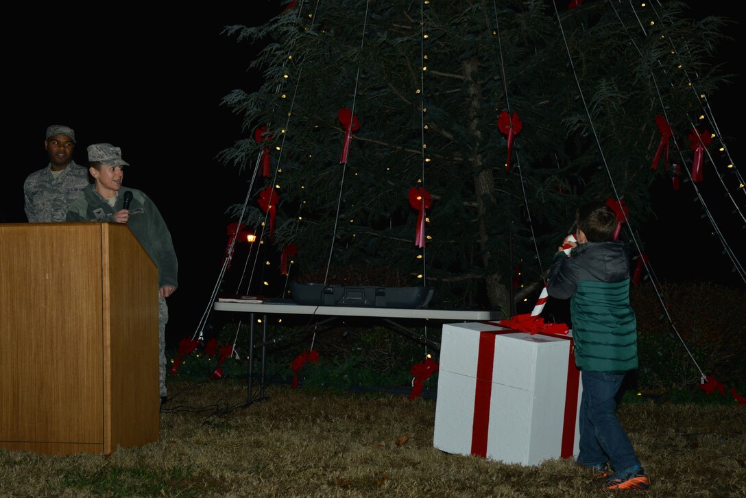 Ryan A. Miller, age 8, son of U.S. Air Force Col. Caroline M. Miller, 633rd Air Base Wing commander, pulls the lever to light the tree during the Holiday Tree Lighting ceremony at Joint Base Langley-Eustis, Va., Dec. 8, 2016. The tree lighting ceremony included music, entertainment, a holiday social and photos with Santa Claus. (U.S. Air Force photo by Airman 1st Class Tristan Biese)