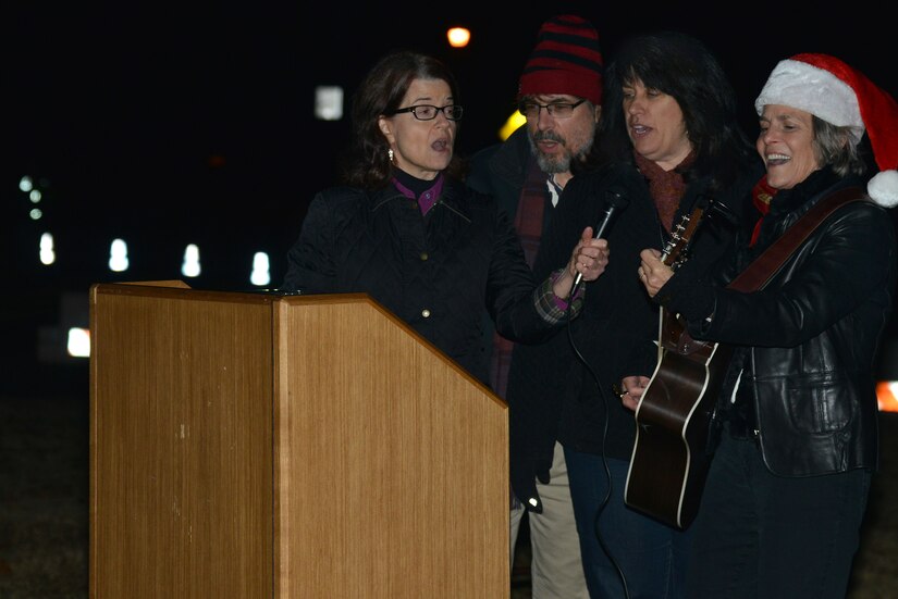 Tidewater Arts Outreach carolers sing holiday songs during the Holiday Tree Lighting ceremony at Joint Base Langley-Eustis, Va., Dec. 8, 2016. Children assisted the carolers in singing, “Here Comes Santa Claus,” as Santa made his surprise appearance. (U.S. Air Force photo by Airman 1st Class Tristan Biese)