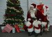 Santa Claus invites service members and their families to take photos with him after the Holiday Tree Lighting ceremony at Joint Base Langley-Eustis, Va., Dec. 8, 2016. This year marked the 49th annual tree lighting ceremony at Langley. (U.S. Air Force photo by Airman 1st Class Tristan Biese)