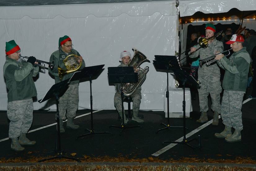 The Air Combat Command Heritage of America Band plays holiday music while children visit Santa Claus after the Holiday Tree Lighting ceremony at Joint Base Langley-Eustis, Va., Dec. 8, 2016. After the tree lighting ceremony, attendees were invited to a holiday social for refreshments and a chance to meet with Santa. (U.S. Air Force photo by Airman 1st Class Tristan Biese)