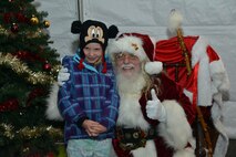 Cora Pawling, age 7, daughter of U.S. Air Force Lt. Col. Carl Pawling, 2nd Manpower Requirement Squadron commander, poses with Santa after the 49th annual Holiday Tree Lighting ceremony at Joint Base Langley-Eustis, Va., Dec. 8, 2016. Santa Claus visited with children after the ceremony to ask what gifts they wanted this holiday season. (U.S. Air Force photo by Airman 1st Class Tristan Biese)