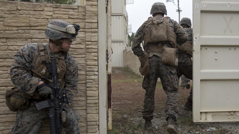 Lance Cpl. Carmona Garcia with 2nd Battalion, 2nd Regiment, 2nd Marine Division gets ready to follow his team into a Military Operations Urban Terrain course at Marine Corps Base Camp Lejeune, N.C., Dec. 8th, 2016. MOUT is a combat course that allows Marines to train in an urban environment in which they secure buildings while taking possible enemy fire.