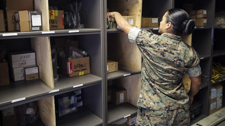 Sgt. Angie Novoa, a warehouse chief with Special Purpose Marine Air-Ground Task Force Crisis Response-Africa, organizes a shelf in her warehouse on Naval Air Station Sigonella, Italy, Oct. 28, 2016.  Novoa was awarded the non-commissioned officer of the quarter for her exemplary work in and out of the supply shop while deployed with SPMAGTF-CR-AF.