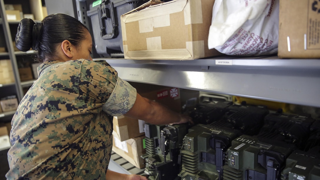 Sgt. Angie Novoa, a warehouse chief with Special Purpose Marine Air-Ground Task Force Crisis Response-Africa, organizes a shelf in her warehouse on Naval Air Station Sigonella, Italy, Oct. 28, 2016.  Novoa was awarded the non-commissioned officer of the quarter for her exemplary work in and out of the supply shop while deployed with SPMAGTF-CR-AF.