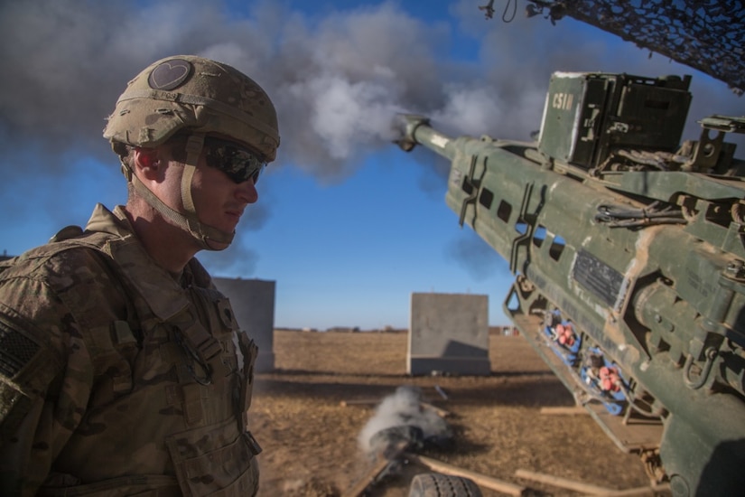 A soldier assigned to Charlie Battery, 1st Battalion, 320th Field Artillery Regiment, observes as an M777 A2 howitzer fires in support of Iraqi forces during the Mosul offensive at Platoon Assembly Area 14, Iraq, Dec. 7, 2016. Charlie Battery conducted the fire mission in support of Combined Joint Task Force Operation Inherent Resolve, the global coalition to defeat ISIL in Iraq and Syria. Army photo by Spc. Christopher Brecht