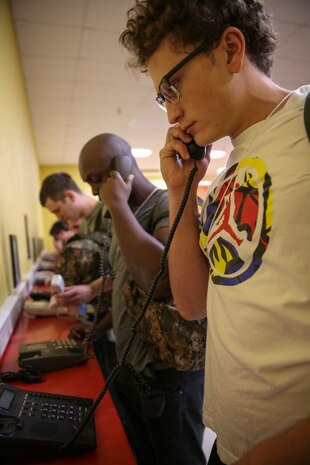Recruits from Hotel Company, 2nd Recruit Training Battalion, make their phone calls home, reading only what is printed on the script in front of them, during receiving at Marine Corps Recruit Depot San Diego, Dec. 12. Recruits will not be able to make another phone call until the end of recruit training. Annually, more than 17,000 males recruited from the Western Recruiting Region are trained at MCRD San Diego. Hotel Company is scheduled to graduate March 10.