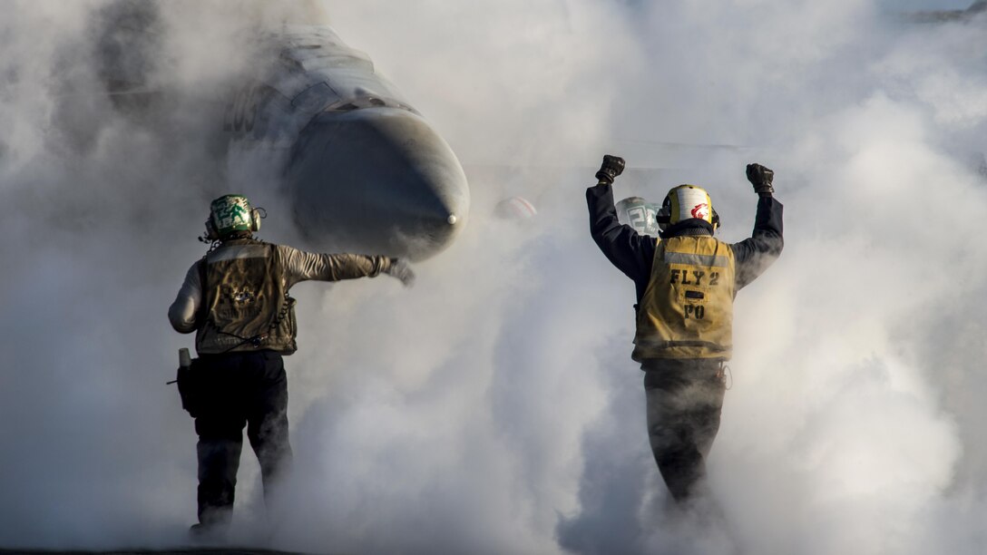 <strong>Photo of the Day: Dec. 14, 2016</strong><br/><br />Navy Petty Officer 1st Class Jeremy Parrish signals to the pilot of an F/A-18E Super Hornet on the flight deck of the USS Dwight D. Eisenhower in the Mediterranean Sea, Dec. 10, 2016. The Hornet is assigned to Strike Fighter Squadron 86. The aircraft carrier is supporting U.S. national security interests in Europe. Navy photo by Petty Officer 3rd Class Nathan T. Beard<br/><br /><a href="http://www.defense.gov/Media/Photo-Gallery?igcategory=Photo%20of%20the%20Day"> Click here to see more Photos of the Day. </a>