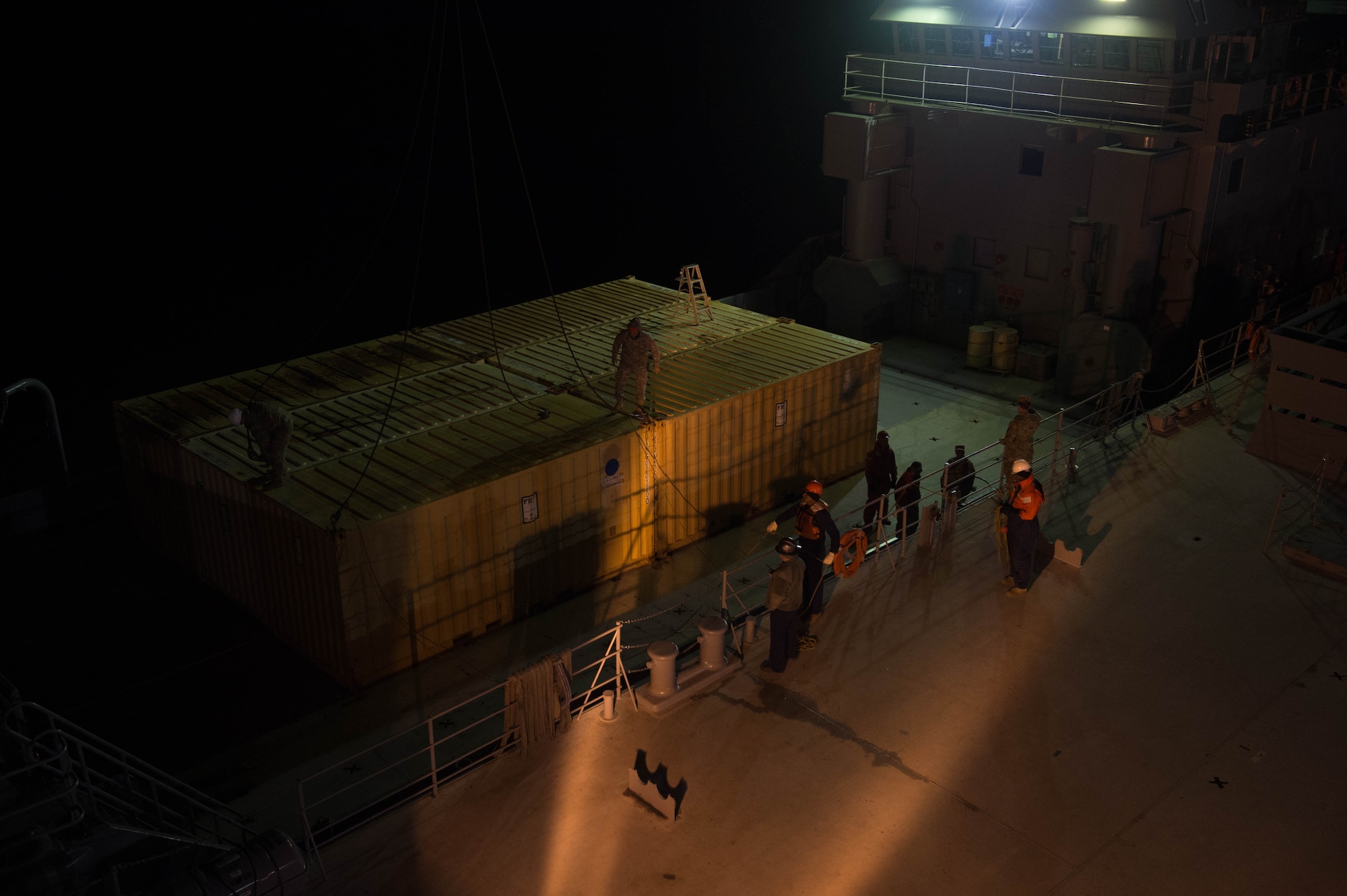 U.S. Army and U.S. Navy service members unload cargo during exercise Operation Resolute Endeavor II at Joint Base Langley-Eustis, Va., Dec. 7, 2016. The service members worked together to unload cargo while U.S. Air Force Security Forces members provided security during the exercise. (U.S. Air Force photo by Airman 1st Class Derek Seifert)