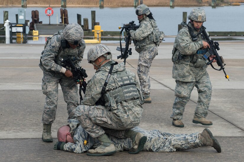 U.S. Air Force Airmen from the 633rd Security Forces Squadron arrests simulated aggressor during exercise Operation Resolute Endeavor II at Joint Base Langley-Eustis, Va., Dec. 5, 2016. The 633rd SFS Airmen confronted aggressors who were using vehicle-borne improvised explosive devices, waterborne infiltration techniques and silent infiltration techniques to gain access to Third Port. (U.S. Air Force photo by Airman 1st Class Derek Seifert)