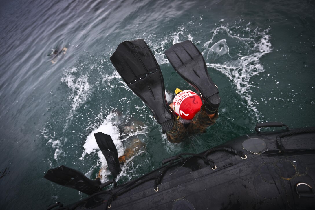 Marines with 4th Force Reconnaissance Battalion depart from a combat rubber raiding craft during dive operations in Kaneohe Bay, Hawaii, Dec. 9, 2016. The mission of Marine Corps Base Hawaii is to provide facilities, programs and services in direct support of units, individuals and families in order to enhance and sustain combat readiness for all operating forces and tenant organizations aboard MCB Hawaii. (U.S. Marine Corps photo by Cpl. Aaron S. Patterson/Released)