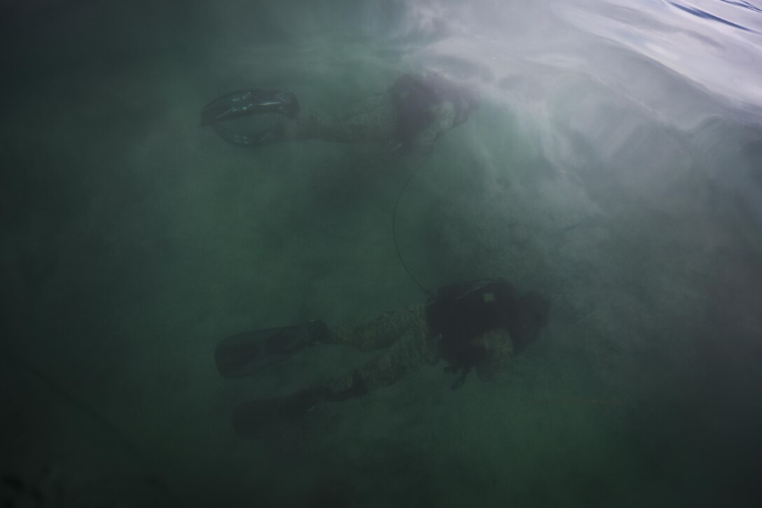 Marines with 4th Force Reconnaissance Battalion conduct underwater navigation training during dive operations in Kaneohe Bay, Hawaii, Dec. 9, 2016. The mission of Marine Corps Base Hawaii is to provide facilities, programs and services in direct support of units, individuals and families in order to enhance and sustain combat readiness for all operating forces and tenant organizations aboard MCB Hawaii. (U.S. Marine Corps photo by Cpl. Aaron S. Patterson/Released)